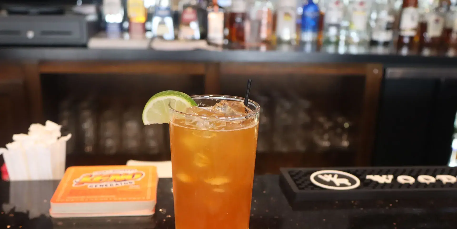 A Dark & Stormy on the bar at The Black Oak, with the back bar beyond.